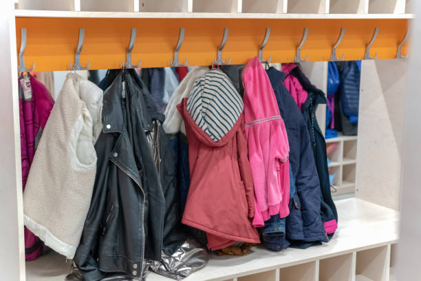 Wardrobe closet full of colorfull clothes in dressing-room. locker room on a hanger hanging clothes Wardrobe closet full of colorfull clothes in dressing-room. locker room on a hanger hanging clothes cloakroom stock pictures, royalty-free photos & images