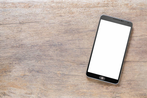 istock Smartphone with white screen on vintage grunge wooden background 1160924056