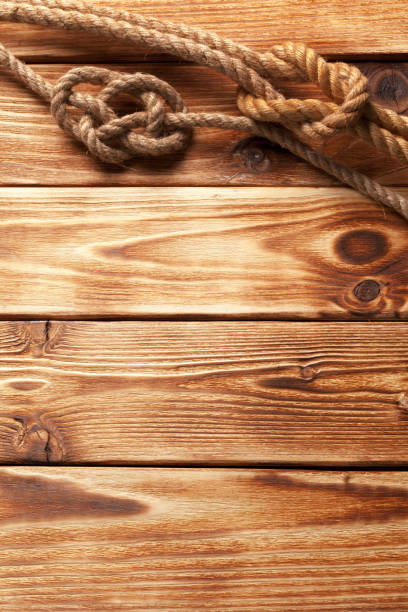 istock ship rope at wooden background 1160924176