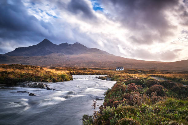 Lonely white cabin in a valley near Sligachan Bridge on Isle of Skye, scotland stock photo