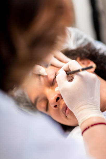 istock Multi-ethnic female getting a permanent makeup in a professional make-up center 1160924720