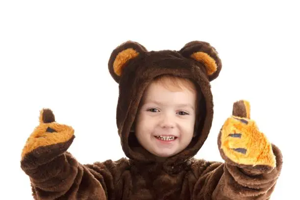 Photo of Child in a christmas carnival bear costume isolated on white with copy space,  carnival.