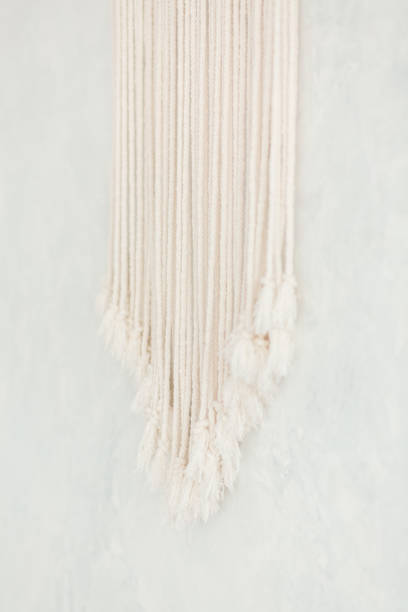 istock Close up of cotton macrame panel fringe in a minimalistic scandinavian wall. Texture. Background. 1160926404