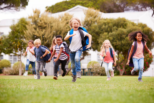 istock Excited Elementary School Pupils Running Across Field At Break Time 1160928797