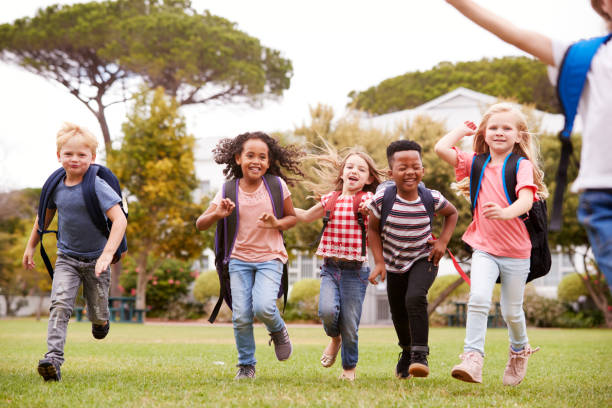 istock Excited Elementary School Pupils Running Across Field At Break Time 1160928956