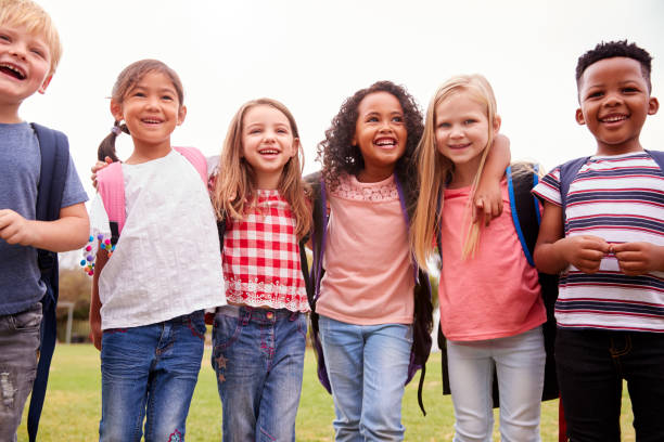 istock Portrait Of Excited Elementary School Pupils On Playing Field At Break Time 1160929152
