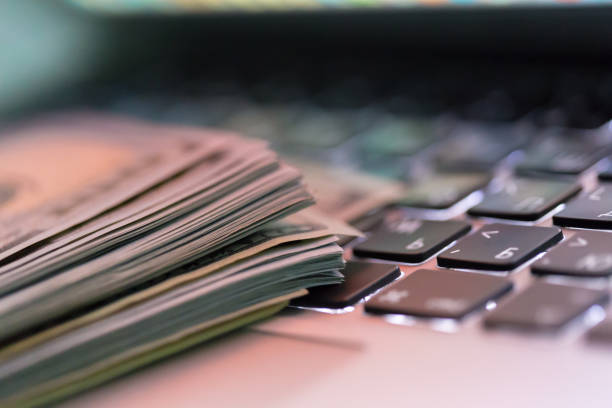 istock money on laptop 1160929214