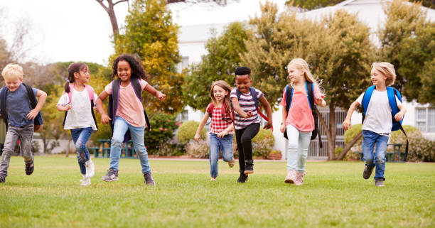 istock Excited Elementary School Pupils Running Across Field At Break Time 1160930471