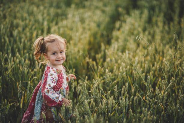 Cute girl walking through meadow