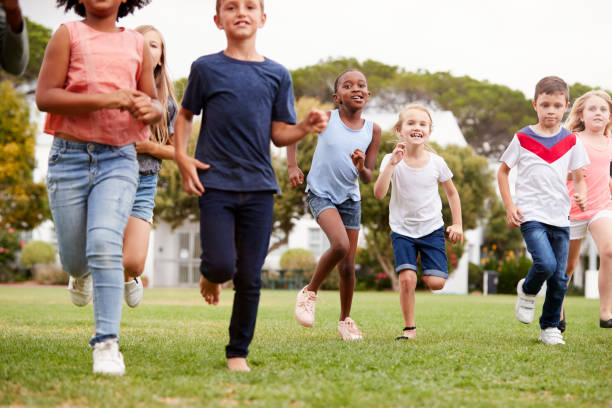 istock Excited Elementary School Pupils Running Across Field At Break Time 1160931207