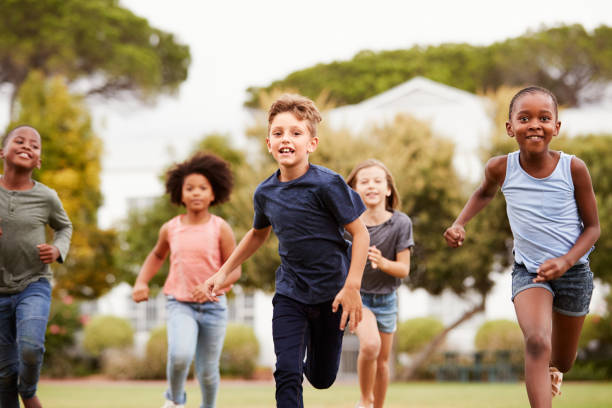 istock Excited Elementary School Pupils Running Across Field At Break Time 1160932314