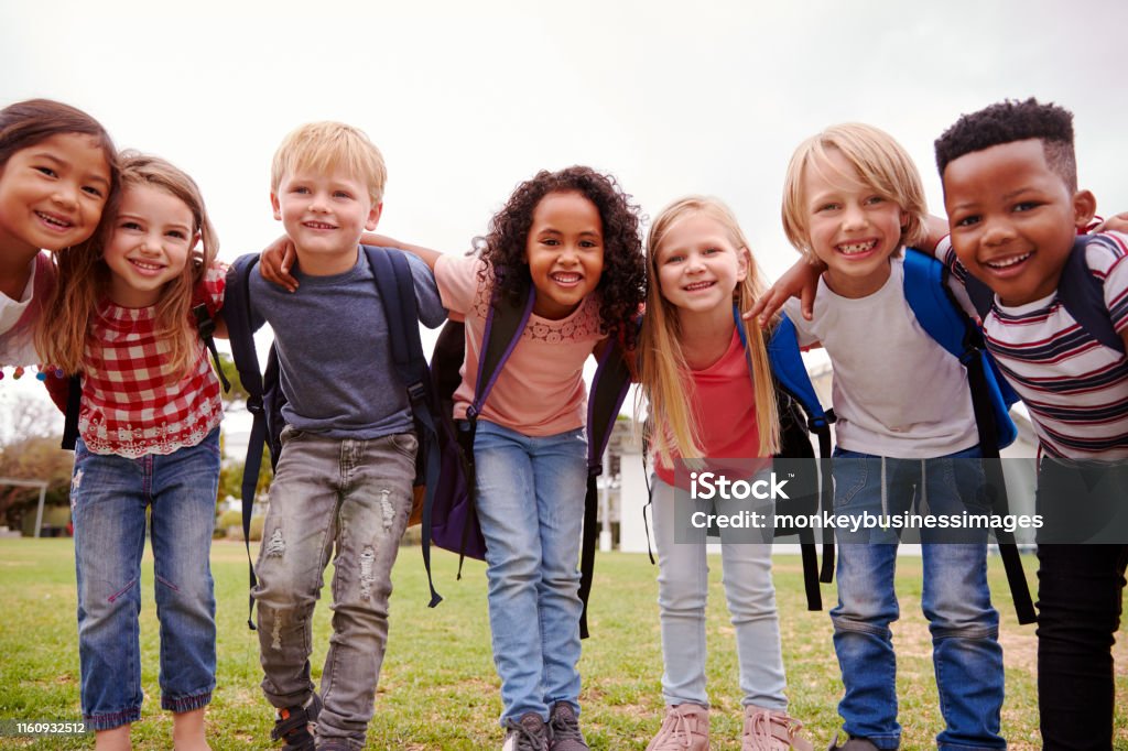 Portrait Of Excited Elementary School Pupils On Playing Field At Break Time Child Stock Photo