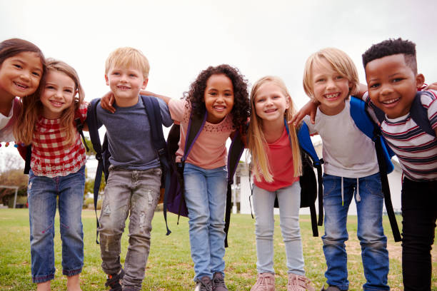 Portrait Of Excited Elementary School Pupils On Playing Field At Break Time Portrait Of Excited Elementary School Pupils On Playing Field At Break Time school children stock pictures, royalty-free photos & images