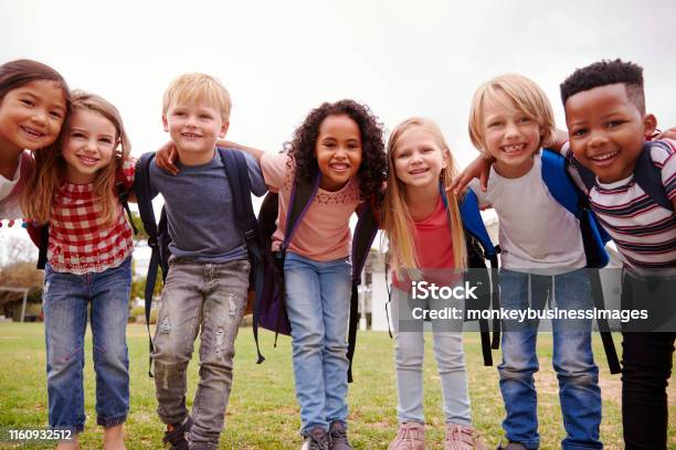 Portrait Of Excited Elementary School Pupils On Playing Field At Break Time Stock Photo - Download Image Now