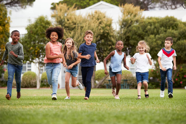 istock Excited Elementary School Pupils Running Across Field At Break Time 1160932585