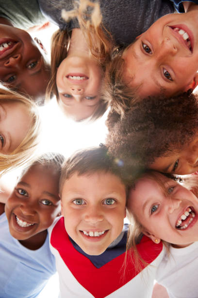 istock Group Of Multi-Cultural Children With Friends Looking Down Into Camera 1160932822