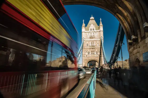 Beautiful long exposure with blurred motion at Tower Bridge in City of London, UK. Dragged exposure technique to capture the busy road traffic and constant commuters and tourist (unrecognisable people) visiting this famous international landmark, connecting City of London directly to the Southwark bank (Unesco heritage site nowadays and build in 1894) . Shot on Canon EOS R full frame system with premium RF lens for highest quality results from a tripod.