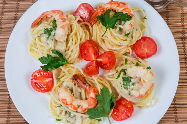 istock Top view of cooked Spaghetti with shrimps and cherry tomatoes 1160934697