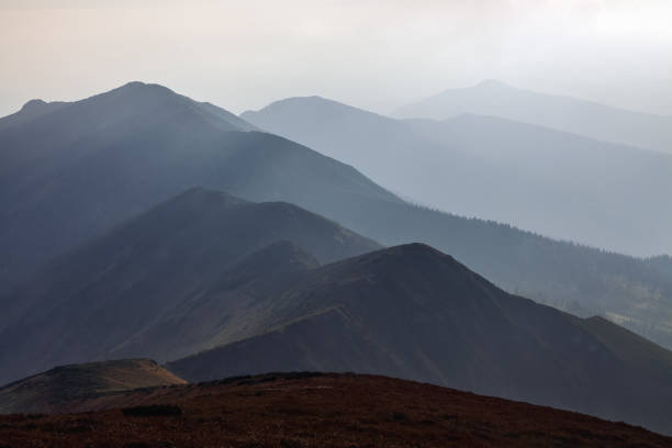 istock From the meadow opens a panoramic view of the mountains. Fantastic spring scenery. Touristic resort Carpathian national park, Ukraine Europe. The sun rays are breaking around. 1160938013