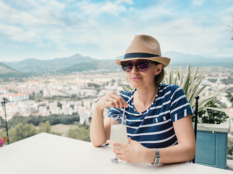 A woman drinks lemonade in a restaurant in Trebinje Bosnia and Hercegovina