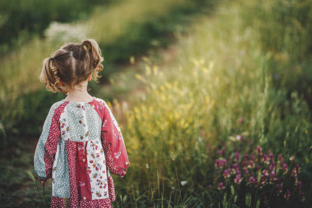 Cute girl walking through meadow