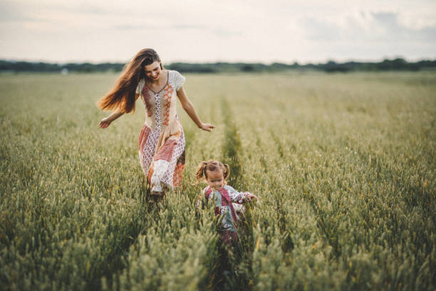 Mother and daughter sharing emotions in meadow
