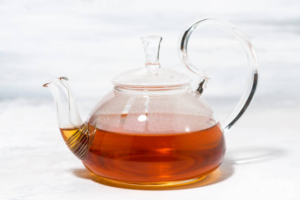 istock tea in a glass teapot on a white background 1160939117