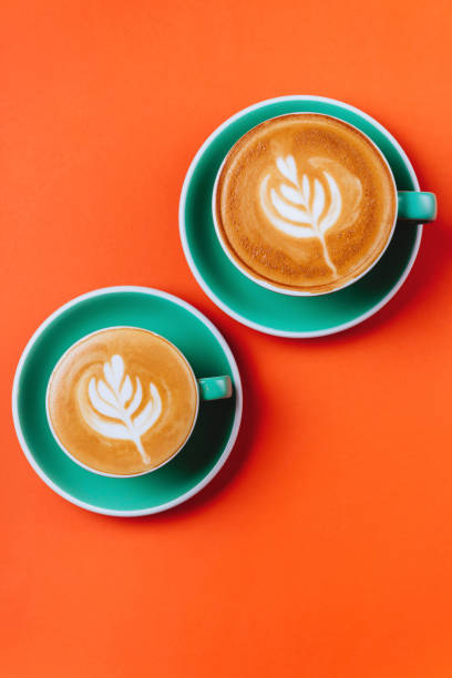 istock Cyan coffee cups over orange background. 1160939359