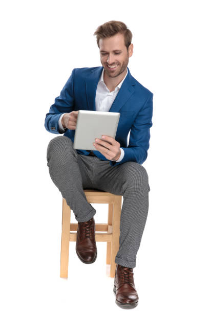 istock olly casual man reading on his tablet and laughing 1160939698