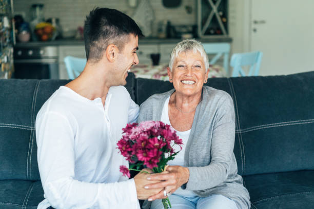 buona festa della mamma! - senior adult child holding grandparent foto e immagini stock