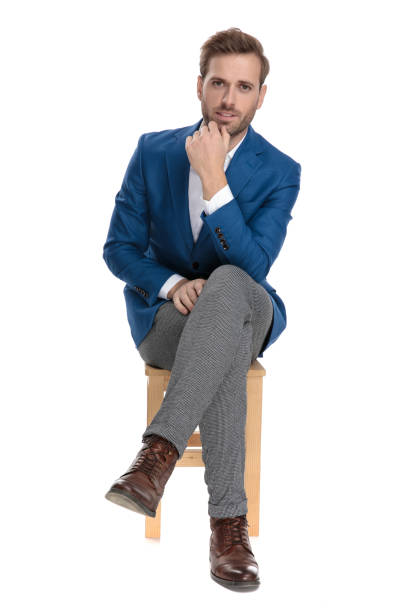 istock Curious casual man holding his hand on his chin 1160941552