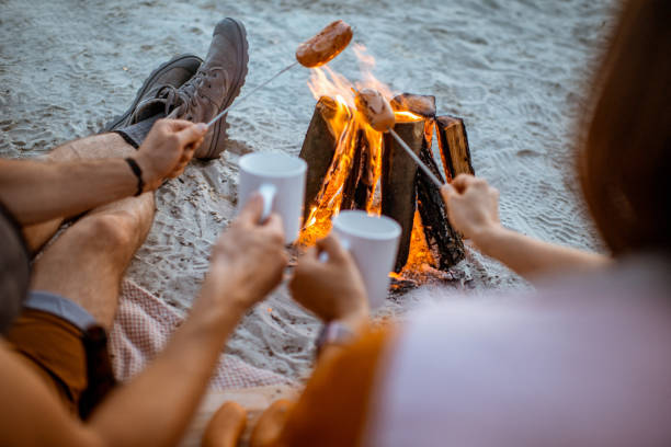 istock Couple cooking sausages on the beach 1160941783