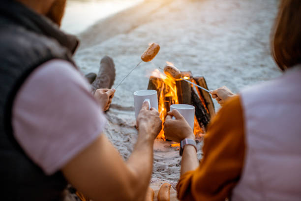 istock Couple cooking sausages on the beach 1160941850