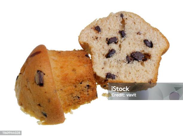Two Halves Of A Sponge Cake Muffin With Chocolate Pieces Isolated Stock Photo - Download Image Now