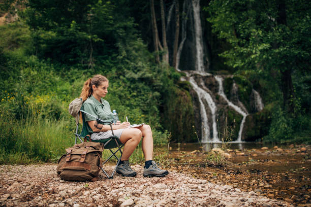 istock Woman biologist contemplating by the waterfall 1160945244
