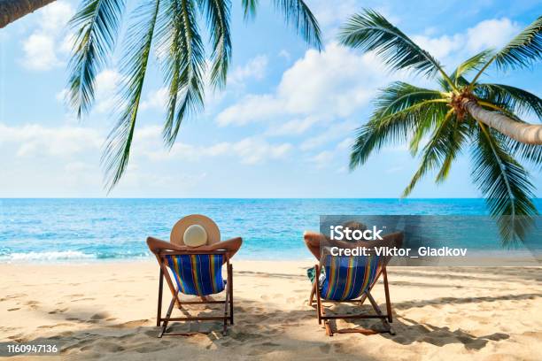Couple Relax On The Beach Enjoy Beautiful Sea On The Tropical Island Stock Photo - Download Image Now