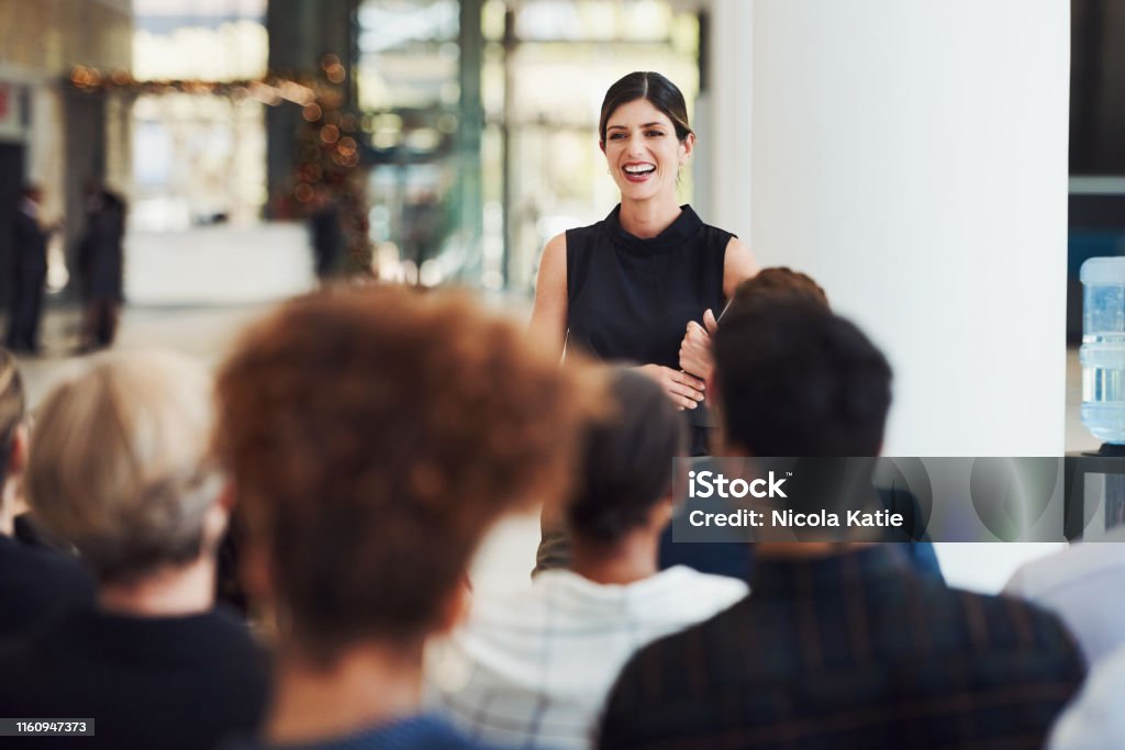 Stay current with trends by learning from powerful speakers Shot of a young businesswoman delivering a speech during a conference Public Speaker Stock Photo