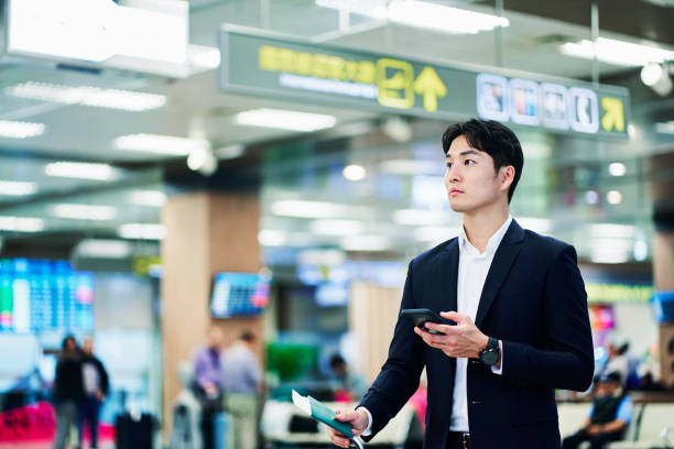 istock Businessman looking away while waiting at airport 1160947606
