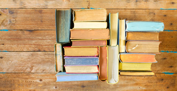 istock Multicolored books, flat lay on old wooden table, reading, education, literature, learning 1160947671