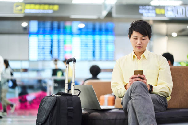 istock businessman using phone while sitting in airport 1160947951