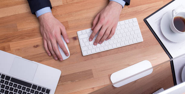 istock A MAN IS WORKING BY USING A LAPTOP ON VINTAGE WOODEN TABLE CONCEPT 1160951914