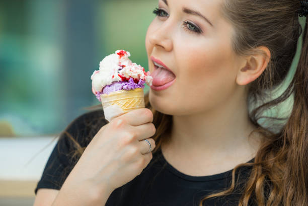 istock Young woman eating ice cream 1160952134