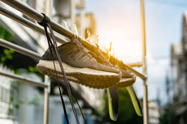 Shoes dangling on a cable over the street have many explanations, from celebrating one's birthday or wedding and making fun of drunk friends, to marking a location of drug dealers and bullying.