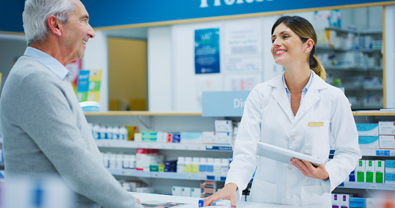 Shot of a pharmacist assisting a customer in a chemist