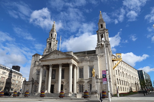 People walk by Civic Hall in Leeds, UK. Leeds urban area has 1.78 million population.