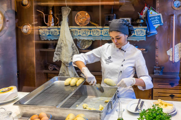 The unidentified staff is preparing codfish cake in Casa Portuguesa do Pastel de Bacalhau, a famous restaurant in Porto. Porto, Portugal - November 15, 2017: The unidentified staff is preparing codfish cake in Casa Portuguesa do Pastel de Bacalhau, a famous restaurant in Porto. restaurant labor union stock pictures, royalty-free photos & images