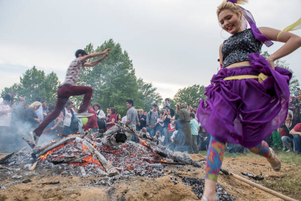 People to jumping from fire during Kakava in Edirne, Turkey. stock photo