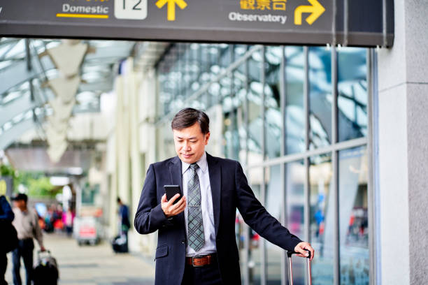 istock Mature businessman using smart phone during travel 1160960716