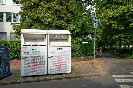 Frankfurt am Main, July 2019.   the boxes of the German red cross for the collection of used clothes on a pavement