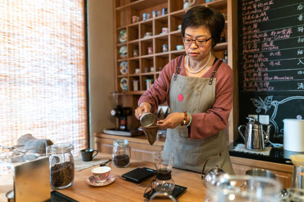 istock Asian mature waitress preparing coffee at coffee lab 1160962557